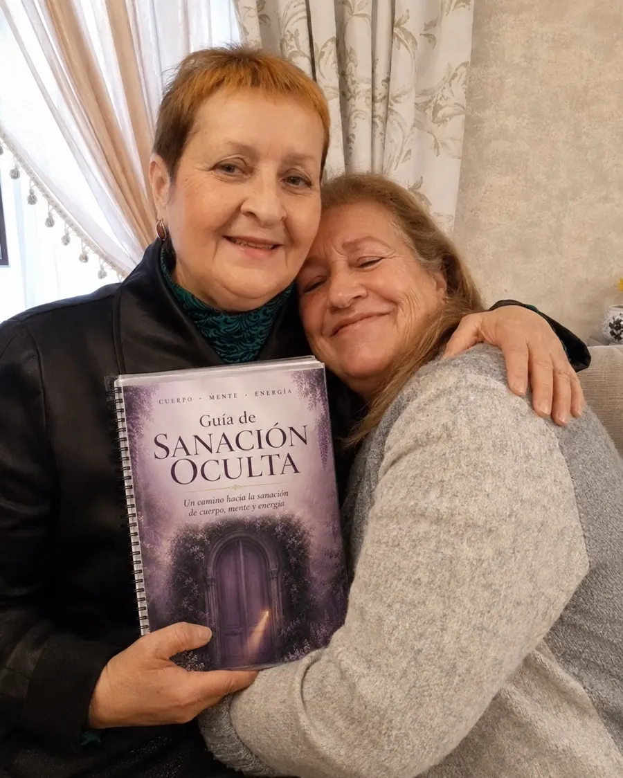 Dos lectoras abrazadas mostrando la Guía de Sanación Oculta